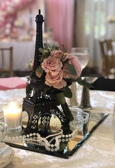 the eiffel tower is decorated with flowers and pearls for an elegant centerpiece