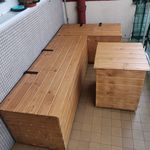 three wooden benches sitting next to each other on a tiled floor in front of a window