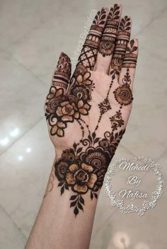 the hand is decorated with henna and flowers