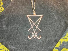 Dark times call for Darkness Jewelry. This custom-made rose gold Sigil of Lucifer / Seal of Satan is truly a sight to behold! Stainless Steel chain is one-size-fits-most and is also rose gold-colored. Show your support of The One behind all of this madness and be saved when He sets foot upon the land. Material: Stainless Steel, Steel Color: Rose Gold Dimensions: Necklace length = 18 inches, Pendant height = 38 millimeters, Pendant width = 22 millimeters Designed in the USA and hand-made in THAIL Nickel-free Rose Gold Metal Jewelry, Adjustable Rose Gold Metal Necklace, Rose Gold Stainless Steel Pendant Jewelry, Rose Gold Stainless Steel Pendant, Rose Gold Stainless Steel Jewelry With Adjustable Chain, Rose Gold Jewelry With Adjustable Chain In Stainless Steel, Nickel Free Rose Gold Stainless Steel Jewelry, Adjustable Rose Gold Stainless Steel Necklace, Symbolic Rose Gold Tarnish Resistant Necklace