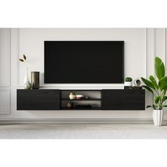 a large flat screen tv mounted to the side of a wall in a living room