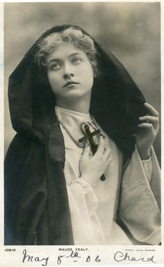 an old black and white photo of a woman with a cross on her neck wearing a nun outfit