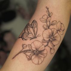 a butterfly and flower tattoo on the arm