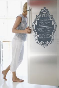 a woman is standing in front of a door with a sign on it that says yume