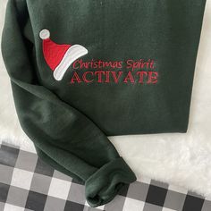 Christmas Spirit Activate Embroidered Sweatshirt.  Hello there! Please message me if you have any additional questions or want to change thread colors. We are a family-run Etsy page; my husband and I make all orders from home. You can also send us a message if you would like a custom sweatshirt/t-shirt with whatever words and images, and we will see if we can accommodate your order! HOW TO ORDER - Please Choose the SIZE and COLOR From Drop Down Menu. MATERIAL - We use JerZees as our blanks; I ma Embroidered Christmas Holiday Sweatshirt, Christmas Holiday Embroidered Sweatshirt, Embroidered Christmas Sweatshirt, Sweatshirt Y2k, Crewneck Vintage, Christmas Crewneck, Thread Colors, Premium Colors, Embroidered Crewneck