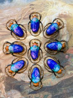 six scarves with blue and orange designs on them are arranged in a circular pattern