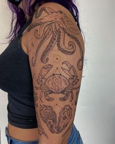 a woman with purple hair and tattoos on her arm