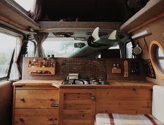 the inside of a camper with wood cabinets and drawers