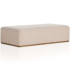 a white ottoman with brown trim on the top and bottom, in front of a white background