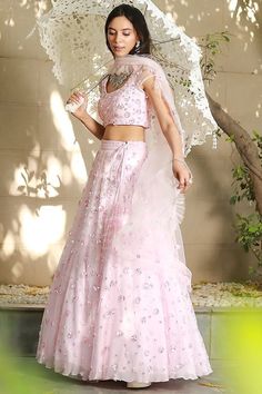 Blush Pink Net Embroidered Lehenga Set Featuring a blush pink lehenga in net base with cutdana and sequins hand embroidery. It is paired with a matching blouse, a cancan and a dupatta. This product will be shipped to you after 1-2 weeks from the date of order placed. All custom made orders are not returnable. Pls contact for Size chart and for other more colors Request You :To provide contact details for courier services. {VARIATION MAY COME DEPENDING UPON AVALIBILITY OF LACES OR GOTTA PATI} NOTE:  1) Visual Samples on website may differ slightly from actual product due to light & effects during photography (Length & Breadth have 1 n 1.5 inches  +/-). 2) Before placing order ,pls confirm product n color availability on +91 7903893945 & +91 8447750028(WhatsApp) 3) For Wholesale Order MOQ is Blush Pink Lehenga, Ruffle Dupatta, Berry Dress, Net Embroidery, Independance Day, Pink Lehenga, Embroidered Lehenga, Krishna Janmashtami, Ganesh Chaturthi