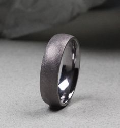 a wedding band that is shiny and grey