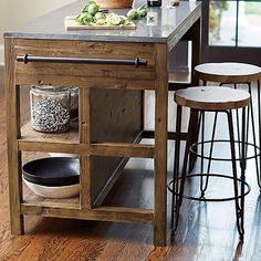 a kitchen island with two stools next to it