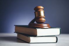 a wooden judge's gavel on top of two books