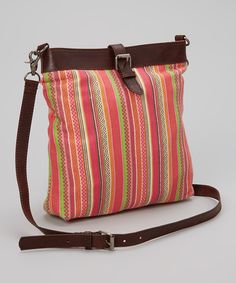 a multicolored striped purse with a brown strap and buckles on the front