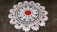 an intricate white and red design on the ground