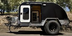 an off - road camper trailer is parked in the shade