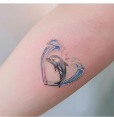 a small dolphin tattoo on the arm