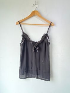 Comme des Garcons 2008 Black Sequin Cami! A sheer top that features black sequins along the collar and has spaghetti straps. 100% polyester. Dry Clean Only. Made in Japan. Marked a size medium. In excellent condition! Approx. Measurements: Underarm to Underarm: 19.5" Length: 25" Embellished Spaghetti Strap Tank Top For Night Out, Evening Camisole With Sequins, Evening Sequined Camisole Top, Sequin Camisole Top For Evening, Embellished Camisole Top For Party, Party Embellished Camisole Top, Embellished Camisole Tops For Evening, Black Silk Camisole Top, Chic Sheer Tank Top For Party