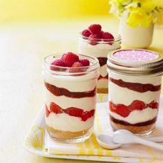 two desserts with raspberries are sitting on a plate