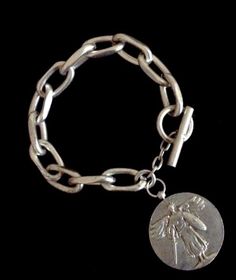 Saint Michael Victory Medal chain link bracelet by Whispering Goddess is made of pewter dipped in Sterling Silver.  The medallion is recast from the American Forces WW2 Victory Medallion. The back of the medallion depicts the great alliance of the Allied Forces who came together to for World Peace.  Saint Michael is s Adventurine Necklace, French Kande, Trinity Necklace, Heart Cross Necklace, Goddess Jewelry, Saint Michael, Wrap Necklaces, Medallion Necklace, Coin Jewelry