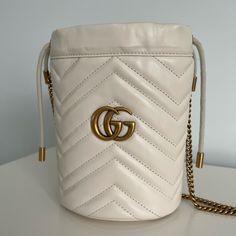 Like New! Used Once And Decided It’s Not My Style. Bought Directly From Gucci Online Currently $1150 Plus Tax Online White Matelass Chevron Leather With A Heart On The Back Antique Gold-Toned Hardware Moir And Microfiber Lining With A Suede-Like Finish Double G Detachable Key Ring 2 Card Slots Chain Strap With 23.6" Drop Drawstring Closure Can Also Be Worn As A Cross Body Bag 5.5"W X 6.7"H X 5.1"D Made In Italy Gucci Bucket Shoulder Bag For Evening, Gucci Evening Bucket Shoulder Bag, Designer Gucci Bucket Shoulder Bag, White Luxury Gucci Shoulder Bag, Luxury White Gucci Shoulder Bag, White Gucci Bag For Formal Occasions, Classic Gucci Bucket Bag, White Gucci Bag For Everyday Luxury, Gucci Formal Bucket Bag