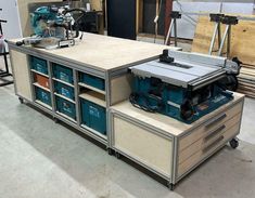 a workbench with drawers and tools on it