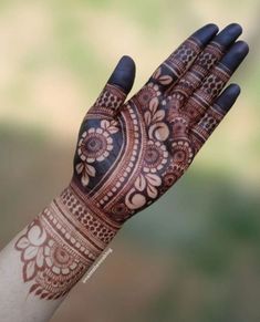 a woman's hand with henna on it