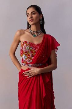 Red solid pre-draped saree with ruffles detailing. Paired with an off shoulder corset style blouse with all over bloom thread embroidery and sequin highlights. - Aza Fashions Red Traditional Drape Blouse For Evening, Elegant Red Pre-draped Saree With Ruffles, Elegant Red Saree With Ruffles, Red Ruffled Sets For Reception, Red Ruffled Sets For Wedding, Red Ruffled Wedding Sets, Fitted Red Georgette Blouse Piece, Fitted Georgette Top With Traditional Drape, Red Blouse With Traditional Drape For Party