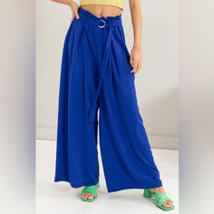 The Paperbag Waist Wide Leg Pants Are A Chic And Trendy Addition To Your Wardrobe. Featuring A Paperbag Waist Design, These Pants Are Flattering And Stylish. The Wide Leg Silhouette Offers A Comfortable And Breezy Fit For All-Day Wear. Pair Them With A Tucked-In Blouse Or Crop Top To Showcase The Unique Waist Detail. These Pants Are Perfect For Both Casual Outings And More Formal Events, Adding A Touch Of Sophistication To Any Outfit. Elevate Your Style With The Fashionable And Versatile Paperba Trendy Blue Belted Bottoms, Blue Belted Summer Bottoms, Spring Blue Belted Bottoms, Versatile High Waist Blue Wide Leg Pants, Trendy Blue Wide Leg Pants For Day Out, Blue Paperbag Waist Bottoms For Spring, Blue High-waisted Wide Leg Pants For Day Out, Blue Wide Leg Pants With Pockets For Day Out, High Waist Blue Wide Leg Pants For Day Out