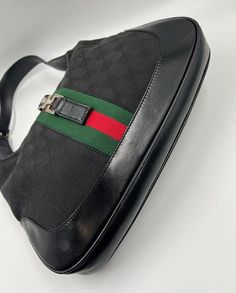 A stunning vintage Gucci Jackie bag made from black canvas with black leather trim and silver hardware. This bag also has the iconic Gucci pin lock closure. Inside the bag is lined with the black Gucci nylon lining and there is a zipped pocket for valuables. This bag is in good vintage condition, with some minor wear to the hardware and leather parts. Height: 19cm Width: 32cm Depth: 4cm Vintage Gucci Jackie, Pin Lock, Vuitton Bag, Diaper Backpack, Black Canvas, New Bag, Leather Trim, Silver Hardware, Gucci Jackie Bag