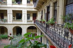 an open balcony with potted plants on the balconies