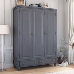 a grey armoire in a white room