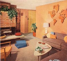 a living room filled with furniture and a fire place next to a wall mounted world map