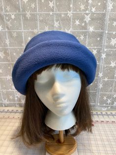 I made this beautiful fleece hat out of a dusty navy anti-pill fleece and lined it with a matching color fleece for warmth and body.  It's sized to fit most adults 22-23 inches around head.  The brim can be worn up or down.  It's a very comfortable fit on my 22 1/2 inch head.  Machine wash and dry, gentle cycle. A great travel hat for any season. Handmade in Oregon. Navy Curved Brim Hat For Winter, Blue Winter Bucket Hat With Curved Brim, Blue Winter Bucket Hat, Blue Winter Hat With Short Brim, Winter Blue Bucket Hat, Blue Cloche Hat With Curved Brim, Dusty Navy Blue, Travel Hat, Fleece Hat