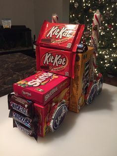 an assortment of kitskats stacked on top of each other in front of a christmas tree