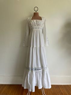 Beautiful gown, Gunne Sax label missing but I have seen this particular style more than twice.  Length: 55", Waist: 13.5" measured at rib from 14" drop from top hem Small stain at bust. Gimme Sax Wedding Dress, White 70s Dress, 1970s Prairie Dress, White Cotton Maxi Dress With Fitted Bodice, White Square Neck Maxi Dress For Wedding, White Bohemian Maxi Dress With Square Neck, Bohemian Fitted Full-length Maxi Dress, Fitted Bohemian Full Length Maxi Dress, Vintage Empire Waist Maxi Dress For Wedding