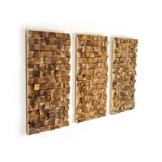 three pieces of wood are hanging on the wall