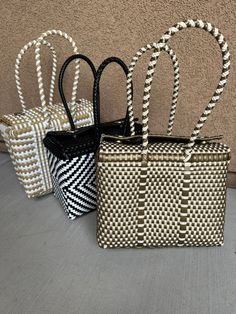 three woven bags sitting next to each other