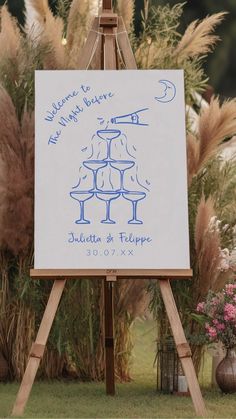 an easel with a drawing on it in front of some plants and flowers,