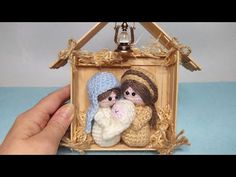 two small stuffed animals are in a miniature house made out of wood and yarns