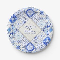 a blue and white plate with an ornate design on the bottom, in front of a white background