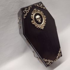 an ornate black box with a skull in the center