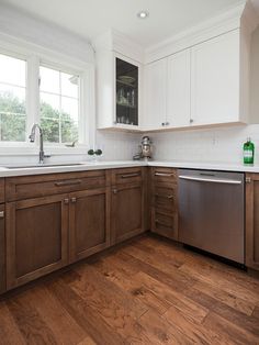 a kitchen with wooden floors and white walls