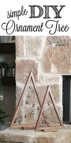 two wooden triangle ornaments sitting on top of a stone fireplace