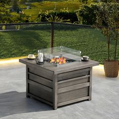 an outdoor fire pit sitting on top of a patio