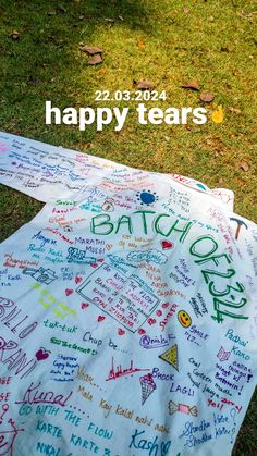 a blanket with writing on it sitting in the grass