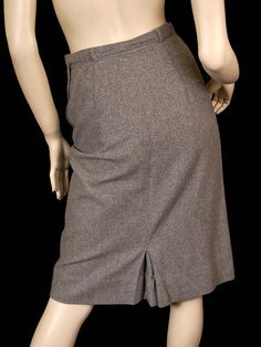 Perfect vintage classic gray pencil pencil skirt with inverted smile pocket on right hip- great detail! Left side metal zipper and a self-belt. Quarter lined in back with silk satin that has the Bernard Altmann logo woven into it. It has a small kickpleat in the back. Label is Bernard Altmann 100% cashmere. Marked Size: None Waist: 26" Hips: 38" Length: 25 1/2" Condition: Excellent- the spot that showed up in the photo was removed by re-cleaning professionally. Retro Fitted Skirt For Formal Occasions, Fitted Retro Skirt For Formal Occasions, Formal Fitted Retro Skirt, Vintage Knee-length Formal Bottoms, Retro Fitted Bottoms For Office, Fitted Vintage Skirt With Pockets, Vintage Fitted Pencil Skirt For Formal Occasions, Vintage Fitted Skirt With Pockets, Classic Gray Fitted Pleated Skirt