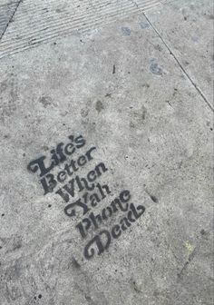 graffiti on the sidewalk that says life is better when you have phone calls written in it