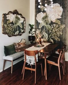 an instagram photo of a dining room with flowers on the wall