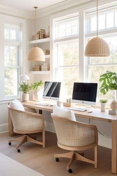 an office with two computers on the desk